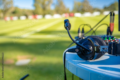 commentator headsets on the table next to the football field. stream for television and radio