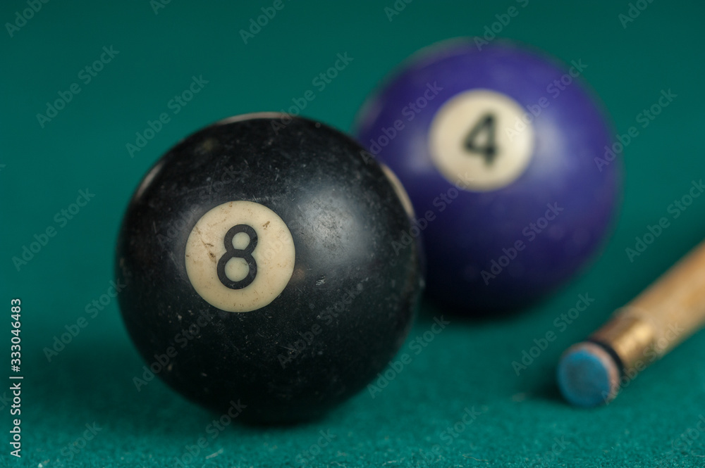 Billiards balls and cue on billiards table. Billiard sport concept.