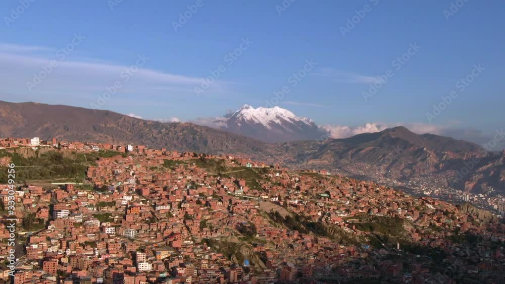 Aerial view of La Paz cityscape and Illimani Mountain at sunset, Bolivia, South America. Aerial view of La Paz cityscape and Illimani Mountain at sunset, Bolivia, South America.