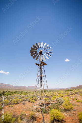 Wide amgle view of a lone windpomp / windmill on the plains of t