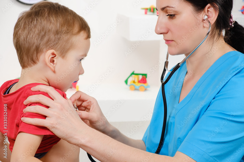 Doctor using stethoscope to examining little sweet boy Doctor using stethoscope to examining little sweet boy