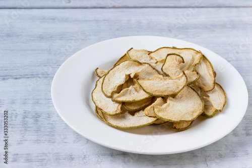 Dried  pear slices  on white plate. Healthy lifestyle.