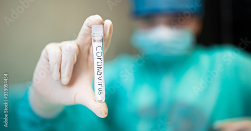 medical test tube with Coronavirus COVID - 2019 in the hands of a researcher of a scientific doctor.
