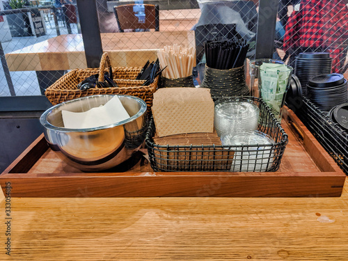 Quadro su tela coffee station with napkins, cardboard sleeves, straws, and sugar packets