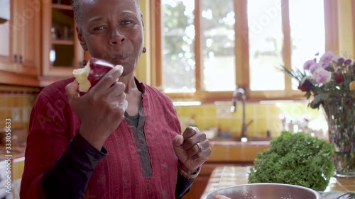 Close up of a healthy senior black woman eating an apple in 4k