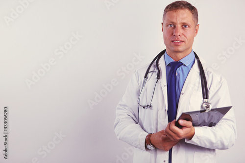 Male doctor standing with folder, isolated on white background