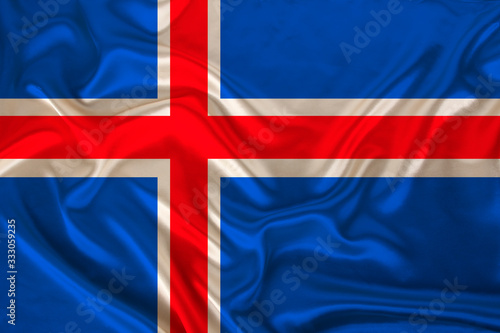 photo of iceland state national flag on luxurious texture of satin, silk with waves, folds and highlights, closeup, copy space, illustration