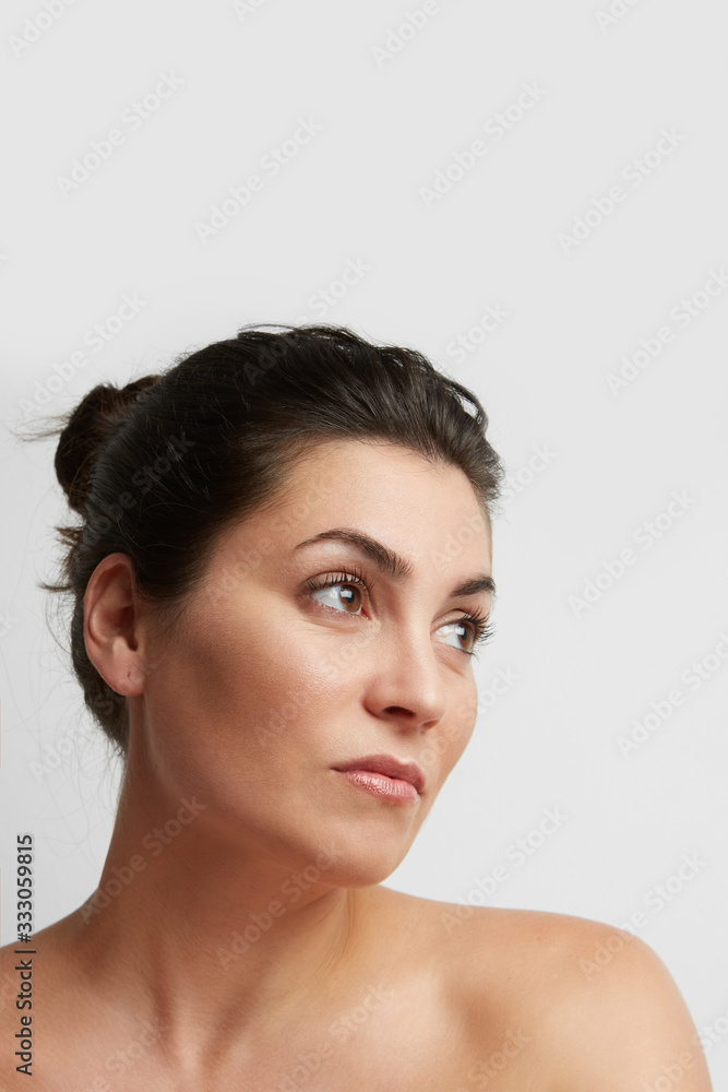 Dark hair beautiful woman posing on the white background. Vertical. Dark hair beautiful woman posing on the white background. Vertical.