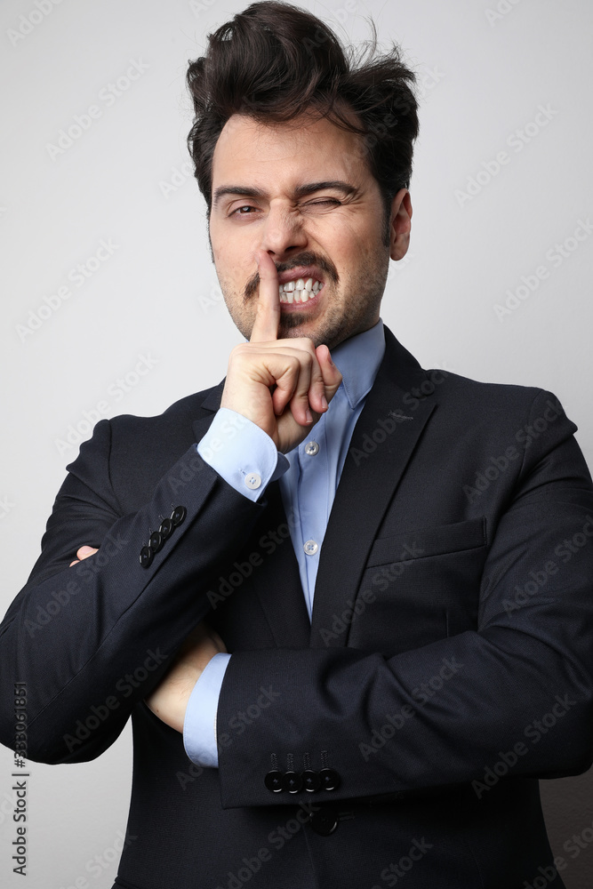 Young business man wearing suit posing at the white background. Horizontal. Young business man wearing suit posing at the white background. Horizontal.