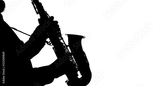 Recital of an actor playing the saxophone, isolated, silhouette, solo