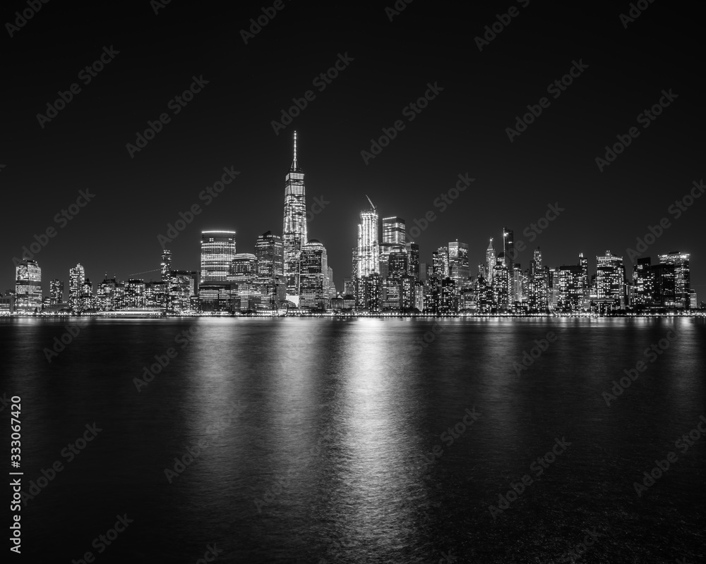 New York City skyline in black and white with reflections in the water.