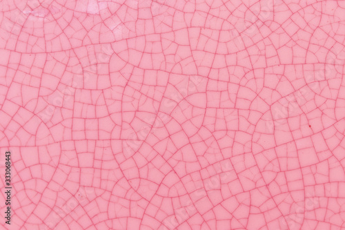 Pink crack ceramic tile. Pale red color of glazed tile texture abstract background. Texture of rose crackle glass mosaic tile.