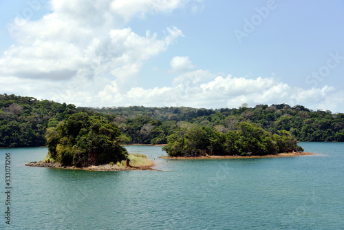 Green landscape of Panama Canal, view from the transiting cargo ship.