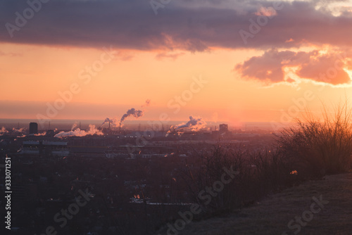 Morning Sunrise Background with Vibrant Skies and Colourful Clouds with industrial buildings in the background