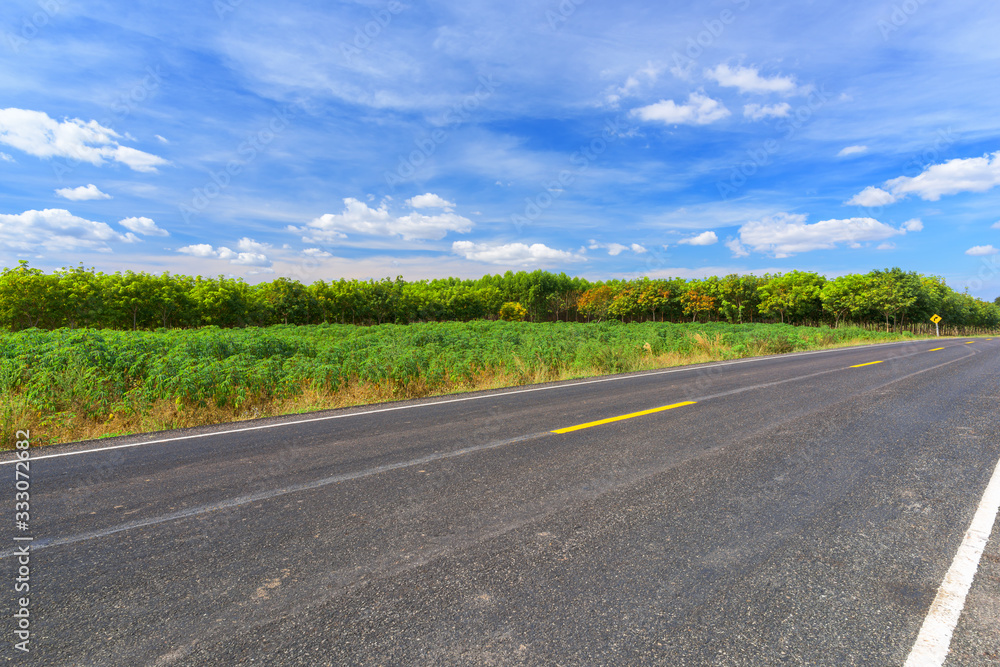 Asphalt road and landscape countryside with blue sky. Asphalt road and landscape countryside with blue sky.