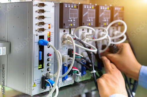 View of communication ports on servo controller in control box of automation machine.