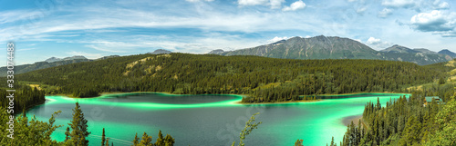 Stunningly beautiful Emerald Lake outside of Whitehorse, Yukon Territory. Summer in famous, tourist, tourism spot with turquoise green water panoramic, panorama view. 