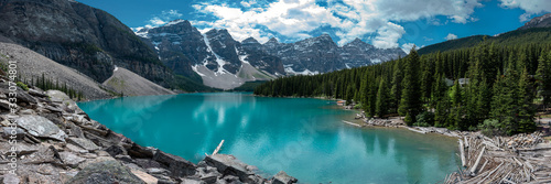 Panoramic view of Moraine Lake in Banff National Park, Canada. Summer in Canada with incredible turquoise, emerald green panorama nature mountains, forest. 