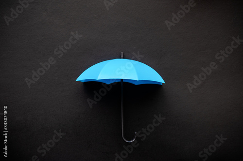 Blue umbrella 3D icon isolated on black background photo