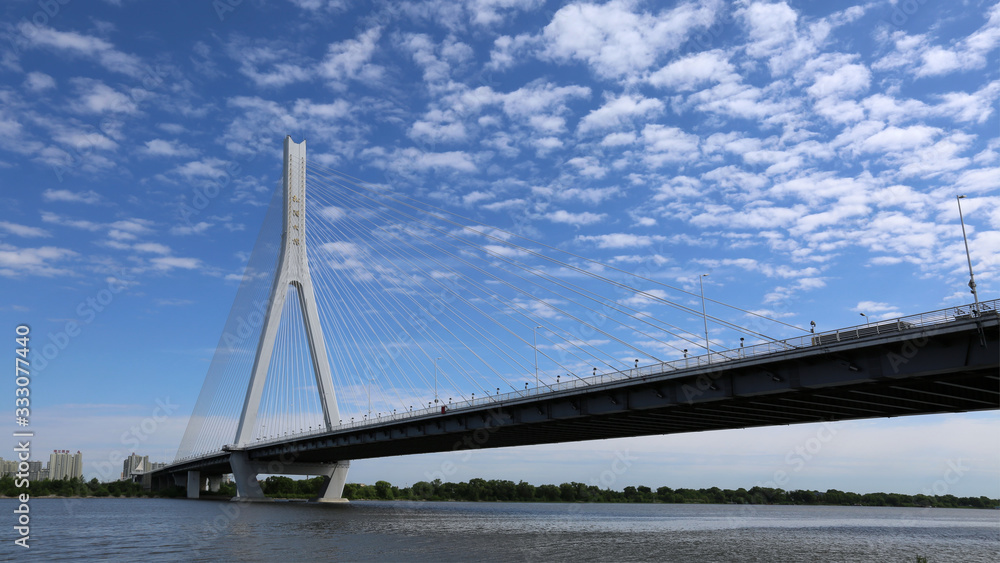 Songpu Bridge under blue sky and white clouds, beautiful famous landmark of Harbin, China. Songpu Bridge