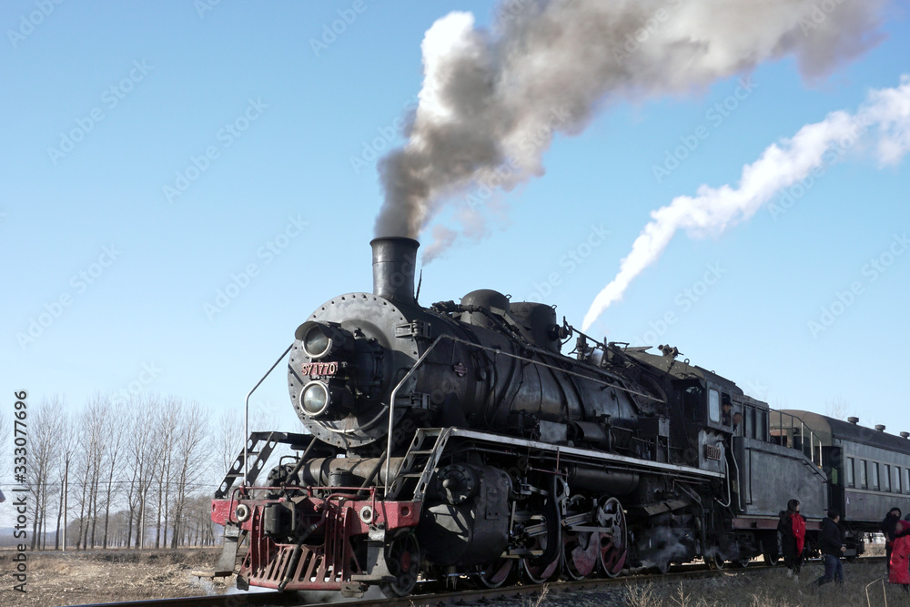 Train ready to leave, close up of steaming locomotive