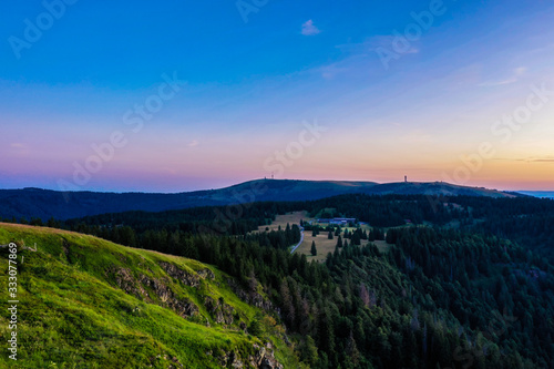 Beautiful sky and green mountains at sunset; natural view of mountains