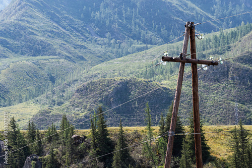 Old wooden poles for power lines in mountainous areas