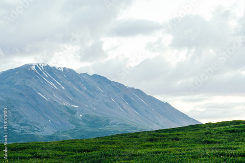 rocky ridge on horizon in mountain valley  green slopes of gentle hills  beauty of nature for relaxation and meditation