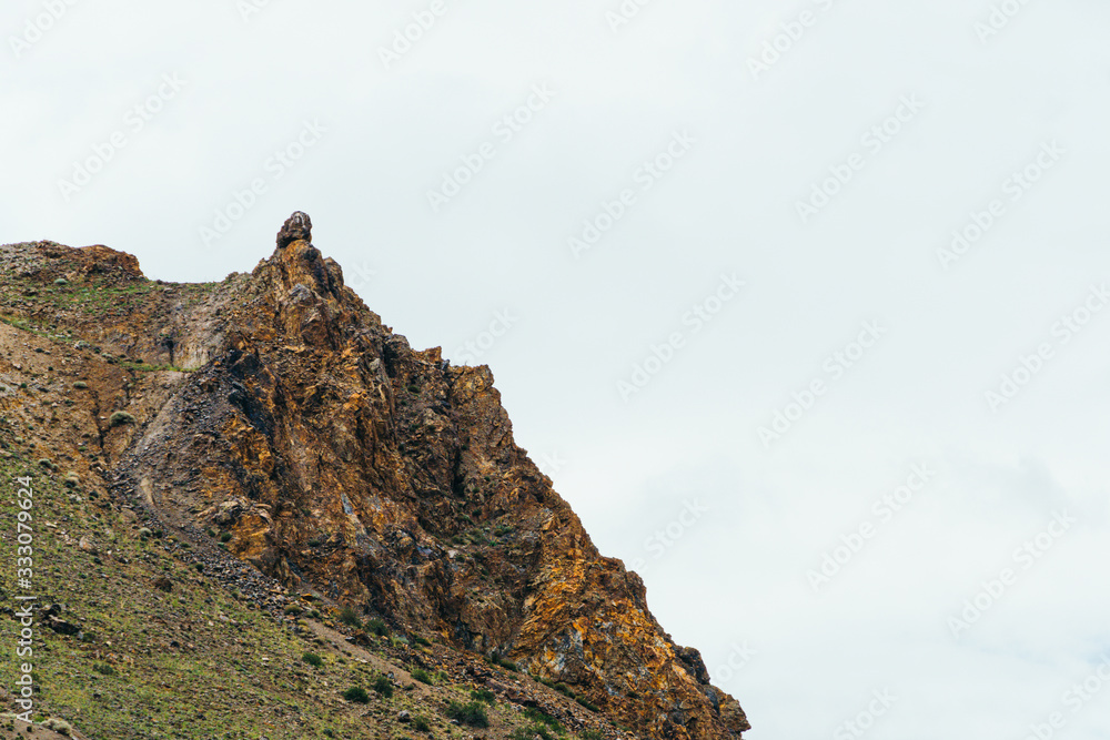 Fototapeta premium rock cliff against sky. Travel in mountains, stone wall for mountaineering