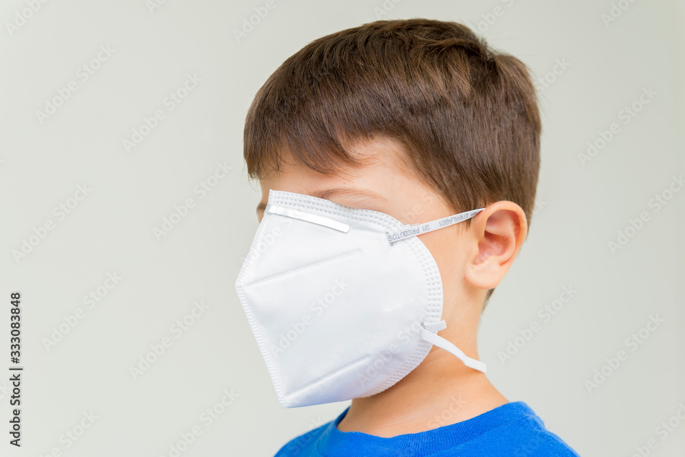 Caucasian boy with surgical mask covering his face. Caucasian boy with surgical mask covering his face.