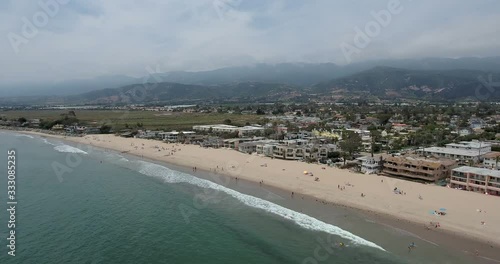 Aerial along world's safest beach near Santa Barbara in Carpinteria, CA.