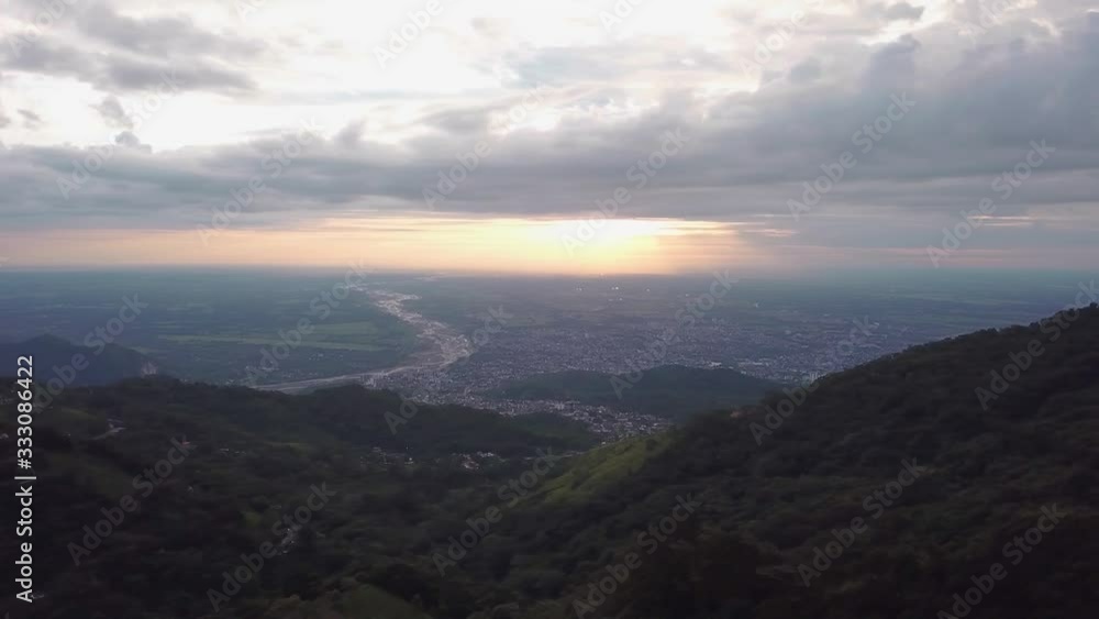 Take aerial with drone, city in Colombia dawning, great mountains with a colorful sky, orange sun. Take aerial with drone, city in Colombia dawning, great mountains with a colorful sky, orange sun.