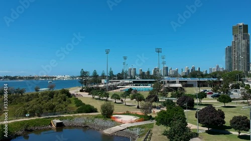 Aerial video of a city green space park area near a popular water spot close to public sports centres photo