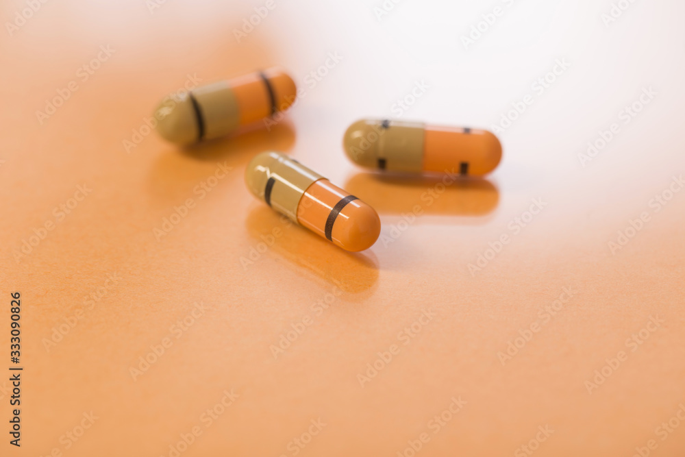 medicines and pills on orange background medicines and pills on orange background