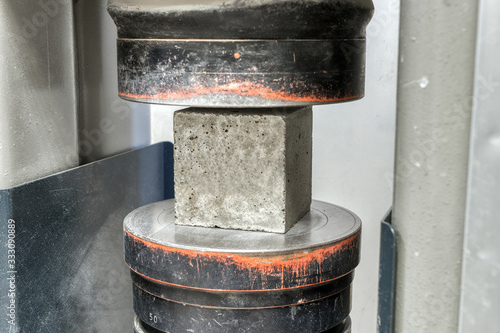 Bild auf Leinwand Concrete cube is installed in a testing machine to conduct a compressive strength test
