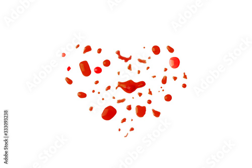 heart shape from red liquid droplets. love symbol drops of red juice on white background