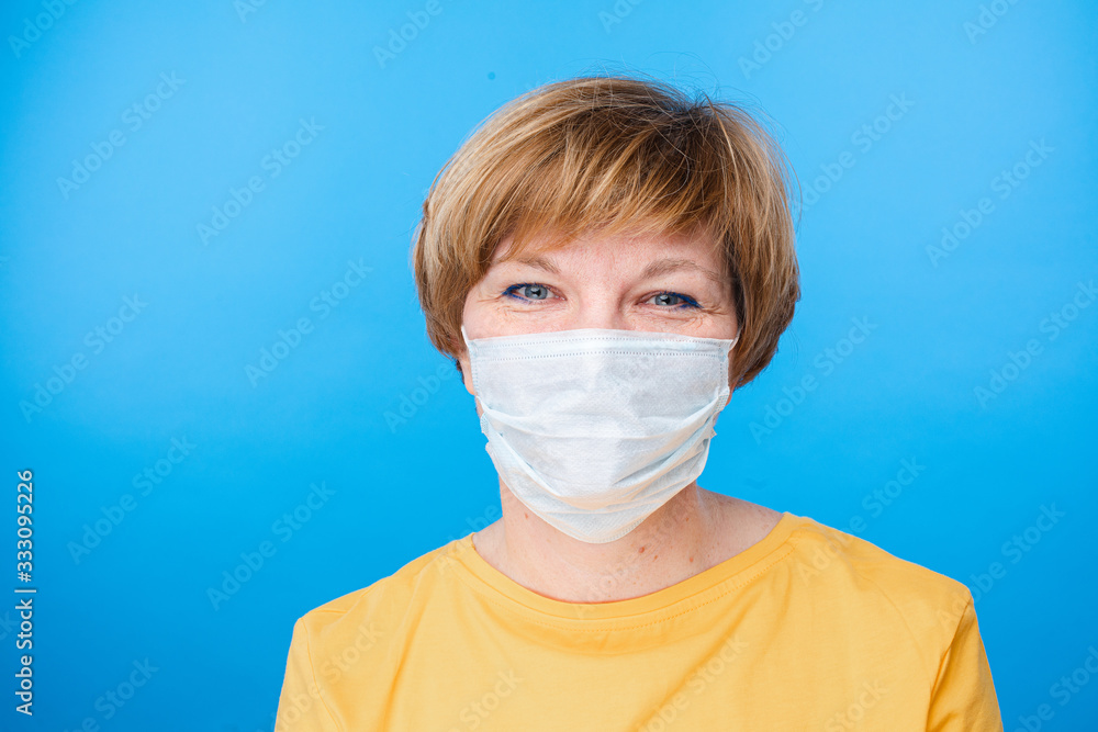 Portrait of caucasian female with short fair hair in yellow t-shirt and special mask rejoices Portrait of caucasian female with short fair hair in yellow t-shirt and special mask rejoices