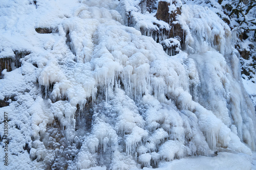 Icy waterfall on a mountain river.