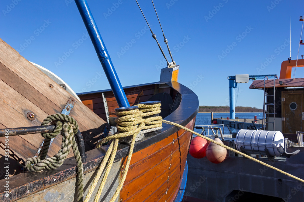 View of the tip of an old sailing boat in the harbour of a village at the Baltic Sea.