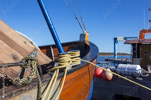 Obraz na płótnie View of the tip of an old sailing boat in the harbour of a village at the Baltic Sea. w salonie
