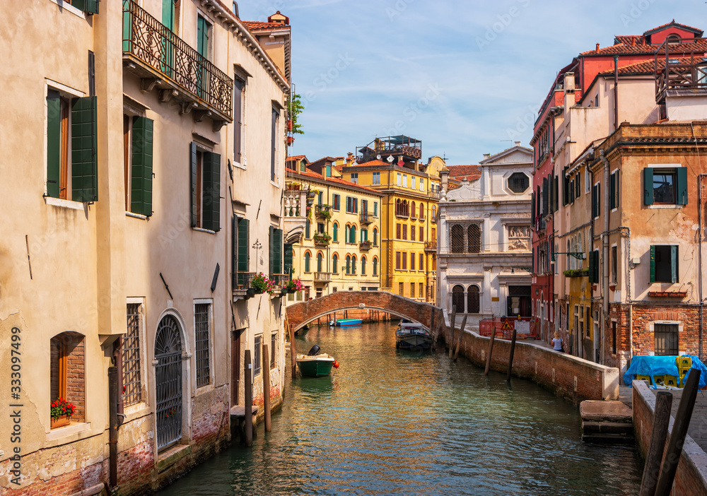 Venice, Italy. Picturesque Vinican landscape with traditional Italian houses and a bridge over the canal.