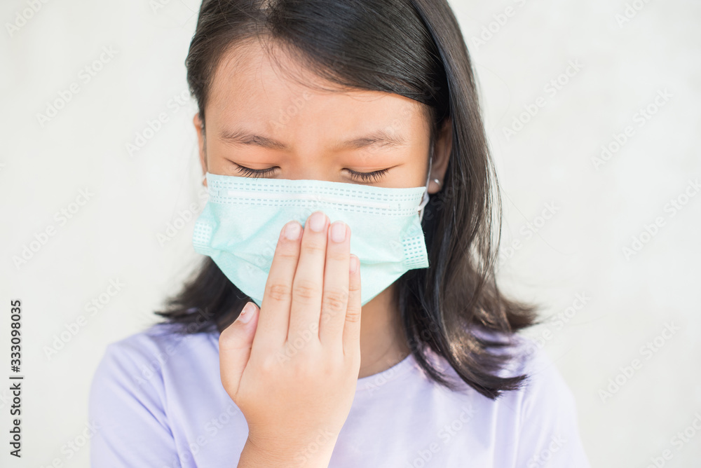asia women wearing hygienic mask to prevent the virus PM2.5, Coronavirus, (2019-nCoV) asian little girl feeling unwell and coughing as symptom for cold or pneumonia,bronchitis. healthcare concept.