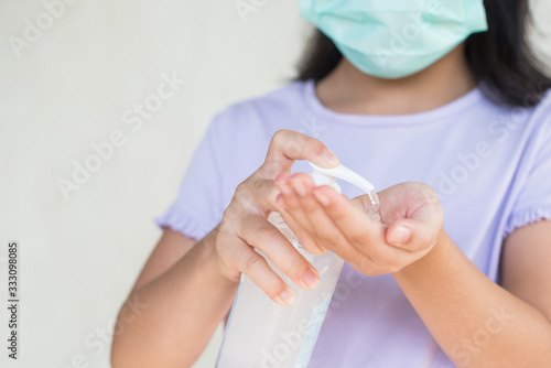 asia women wearing hygienic mask to prevent the virus PM2.5  Coronavirus   2019-nCoV  asian little girl washing hands with alcohol gel or antibacterial soap sanitizer virus. healthcare concept..