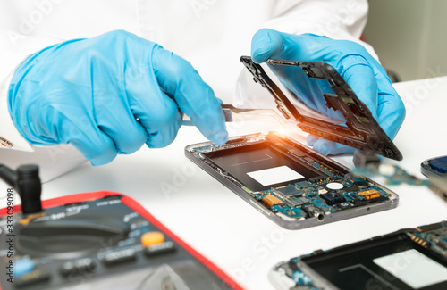 The abstract image of the technician repairing mobile phone in electronic smartphone technology