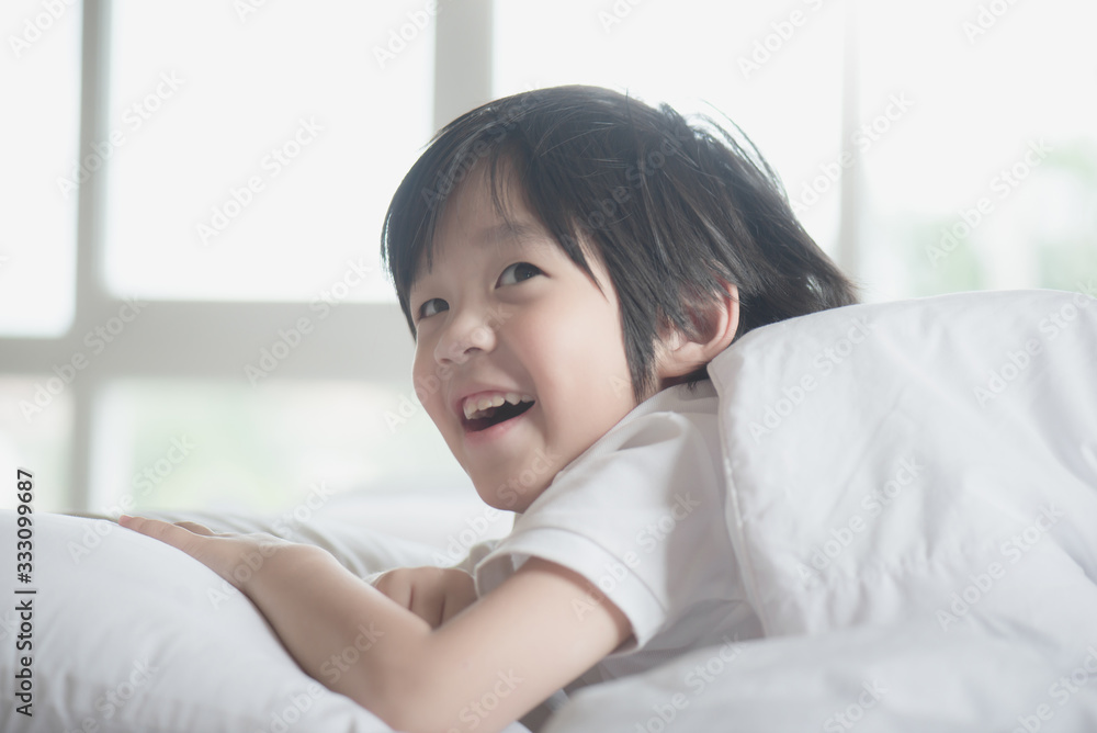 Cute asian child lying on a bed Cute asian child lying on a bed