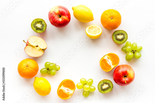 Fototapeta Naklejka Na Ścianę i Meble -  Colorful fruit mockup. Cut apple, kiwi, citrus on white background top-down copy space