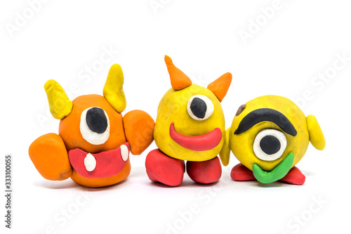 Play dough group monsters on white background. Handmade clay plasticine photo