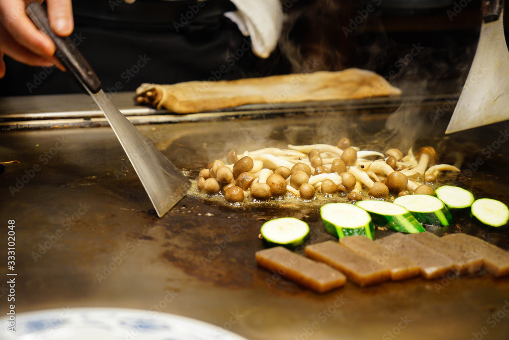 Chef is grilling vegetables at a work in Kobe, Japan.