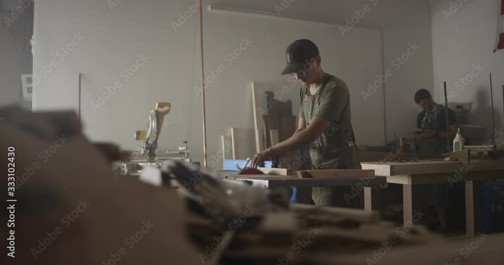 Woodworker man working in garage Woodworker man working in garage