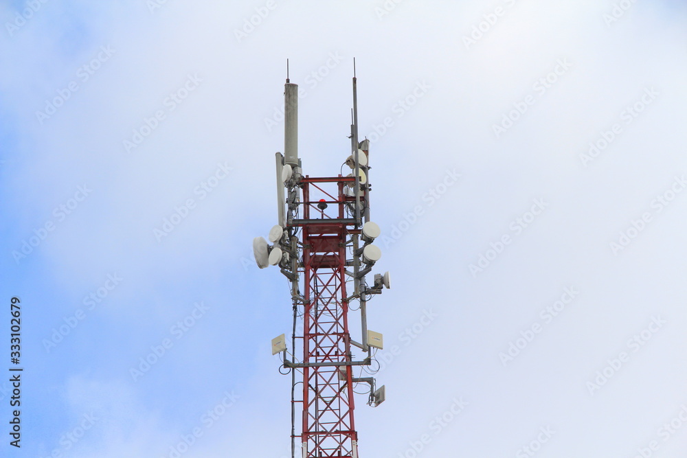 Base station mobile network antenna on a steel structure mast with a repeater.